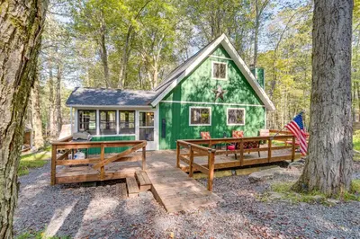 a green tiny house in the woods at Fishing, Fun and Fall Foliage! Pocono Lake Cabin in Pocono Lake