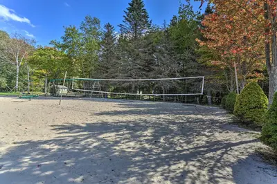a volleyball court with a net in a park at Fishing, Fun and Fall Foliage! Pocono Lake Cabin in Pocono Lake