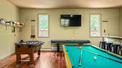 a living room with a pool table and a flat screen tv at Lake Harmony Chalet w Hot Tub Arcades Near Beaches Ski Trails Everpine Lodge by AvantStay in Lake Harmony