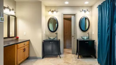 a bathroom with two sinks and two mirrors at Lake Harmony Chalet w Hot Tub Arcades Near Beaches Ski Trails Everpine Lodge by AvantStay in Lake Harmony