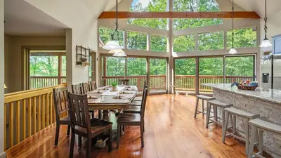 a dining room with a table and chairs at Lake Harmony Chalet w Hot Tub Arcades Near Beaches Ski Trails Everpine Lodge by AvantStay in Lake Harmony