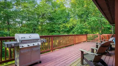 a grill on a deck with a bench and a chair at Lake Harmony Chalet w Hot Tub Arcades Near Beaches Ski Trails Everpine Lodge by AvantStay in Lake Harmony