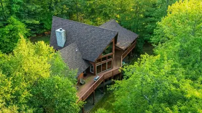 an overhead view of a house in the trees at Lake Harmony Chalet w Hot Tub Arcades Near Beaches Ski Trails Everpine Lodge by AvantStay in Lake Harmony