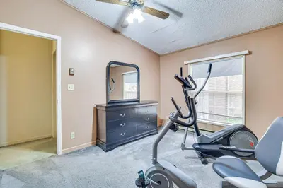 a fitness room with a treadmill and a mirror at 7 Mi to Big Boulder Mtn! Home with Pet-Friendly Yard in Towamensing Trails
