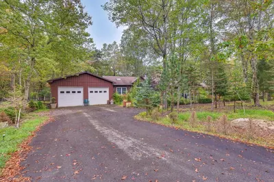 a house with a garage and a driveway at 7 Mi to Big Boulder Mtn! Home with Pet-Friendly Yard in Towamensing Trails