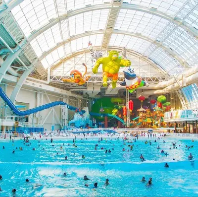 a large indoor swimming pool with people in it at Luxury Queen Studio- Minutes To NYC, EWR & MetLife in Elizabeth
