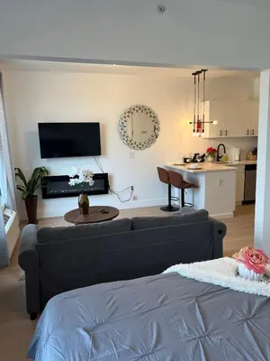 a living room with a couch and a table at Luxury Queen Studio- Minutes To NYC, EWR & MetLife in Elizabeth
