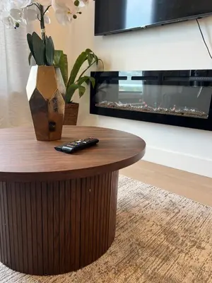 a coffee table in a living room with a fireplace at Luxury Queen Studio- Minutes To NYC, EWR & MetLife in Elizabeth