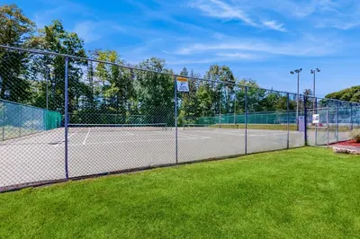 a chain link fence with two tennis courts at Blue Mountain Crossing in East Stroudsburg