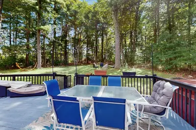 a patio with a table and chairs on a deck at Blue Mountain Crossing in East Stroudsburg