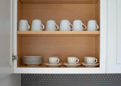 a cupboard filled with plates and cups and saucers at Nyc skyline view, 17m- Manhattan, Prime location in Carlstadt