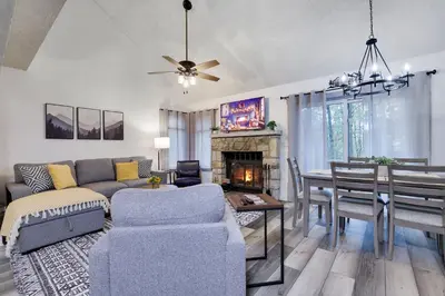 a living room with a couch and a dining room at Cozy 2BR Townhouse with Mountain Views & BBQ in Lake Harmony