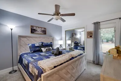 a bedroom with a bed and a ceiling fan at Cozy 2BR Townhouse with Mountain Views & BBQ in Lake Harmony