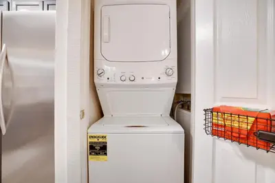a washer and dryer sitting on top of a refrigerator at Cozy 2BR Townhouse with Mountain Views & BBQ in Lake Harmony