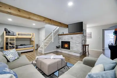 a living room with a couch and a fireplace at Gloria's Hot Tub Game Room Fire Pit in Blakeslee