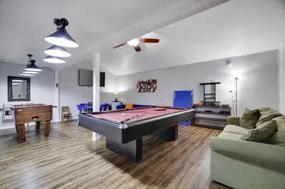 a living room with a pool table in it at Gloria's Hot Tub Game Room Fire Pit in Blakeslee