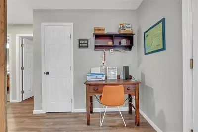 a desk with an orange chair in a room at Gloria's Hot Tub Game Room Fire Pit in Blakeslee