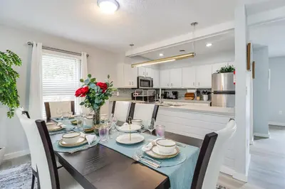 a dining room with a table and chairs and a kitchen at Family Gem with Deck Across From Shawnee Mountain! in East Stroudsburg