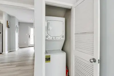 a washer and dryer in a white laundry room at Family Gem with Deck Across From Shawnee Mountain! in East Stroudsburg