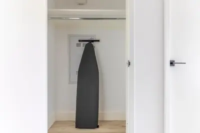 a black umbrella hanging on a wall in a room at Blueground Alphabet City rooftop nr Tompkins Square Park NYC-2057 in New York
