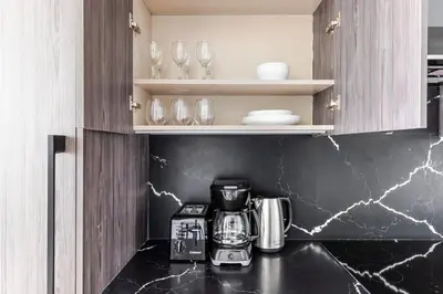 a kitchen with a coffeemaker on a counter at Blueground Alphabet City rooftop nr Tompkins Square Park NYC-2057 in New York
