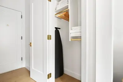 a closet with white doors and white towels at Blueground Lincoln Square view nr Central Park NYC-2065 in New York