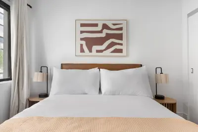 a bedroom with a white bed with two lamps at Blueground Midtown East rooftop nr Grand Central NYC-2069 in New York