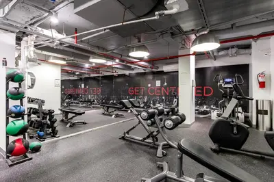 a gym with lots of exercise equipment in a room at Blueground Midtown East rooftop nr Grand Central NYC-2069 in New York