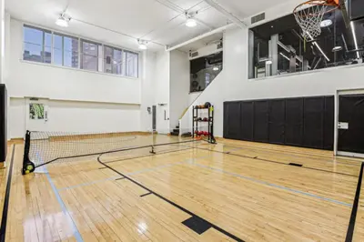 a gym with a basketball court with a net at Blueground Hells Kitchen fitness center nr Hudson River Park NYC-2086 in New York