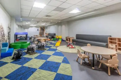 a classroom with desks and tables and chairs at Blueground Lincoln Square fitness center nr Riverside Park NYC-846 in New York