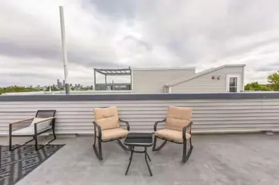 a group of chairs and a table on a patio at Lovely 2BR w Patio - 10 mins to DT - Sleeps 10 in Philadelphia