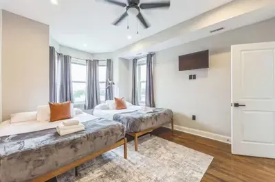 a bedroom with two beds and a ceiling fan at Lovely 2BR w Patio - 10 mins to DT - Sleeps 10 in Philadelphia