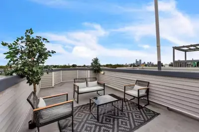 a group of chairs and tables on a roof at Lovely 2BR w Patio - 10 mins to DT - Sleeps 10 in Philadelphia