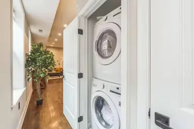 a laundry room with two washer and dryer at Lovely 2BR w Patio - 10 mins to DT - Sleeps 10 in Philadelphia