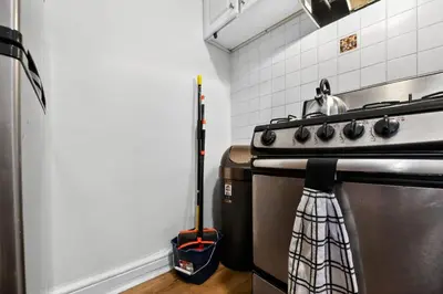 a kitchen with a stove with a mop next to it at Lovely 1BR Center City with King Bed and Sleeper Sofa in Philadelphia