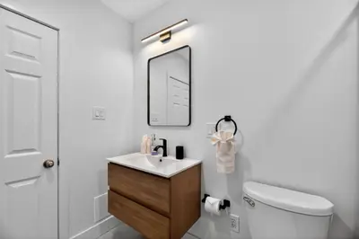 a bathroom with a sink and a toilet and a mirror at Lovely 1BR Center City with King Bed and Sleeper Sofa in Philadelphia