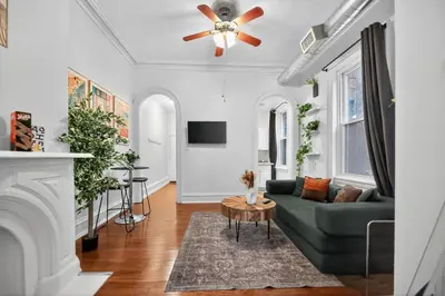 a living room with a couch and a ceiling fan at Lovely 1BR Center City with King Bed and Sleeper Sofa in Philadelphia