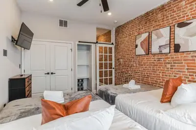 a bedroom with two beds and a brick wall at Jr 1Br w 2 Beds - Sleeps 4 - 10 min to DT in Philadelphia