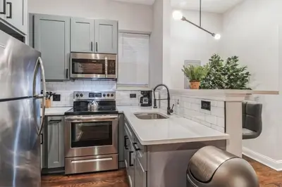 a kitchen with stainless steel appliances and a sink at Jr 1Br w 2 Beds - Sleeps 4 - 10 min to DT in Philadelphia
