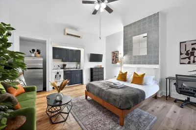 a bedroom with a bed and a living room at Perfect Cozy Studio in Center City with Fast WiFi in Philadelphia