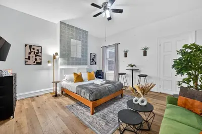 a bedroom with a bed and a living room at Perfect Cozy Studio in Center City with Fast WiFi in Philadelphia