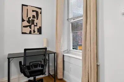 a desk and a chair in a room with a window at Perfect Cozy Studio in Center City with Fast WiFi in Philadelphia