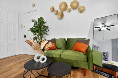 a living room with a green couch and a table at Perfect Cozy Studio in Center City with Fast WiFi in Philadelphia