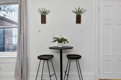 a table and two stools in a room with a wall at Perfect Cozy Studio in Center City with Fast WiFi in Philadelphia