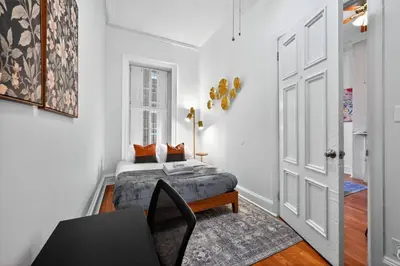 a bedroom with a bed and a table and a window at Sunny 1BR in Center City with King Sized Memory Foam Sofa Bed in Philadelphia