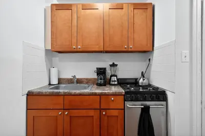 a kitchen with a sink and a stove at Sunny 1BR in Center City with King Sized Memory Foam Sofa Bed in Philadelphia