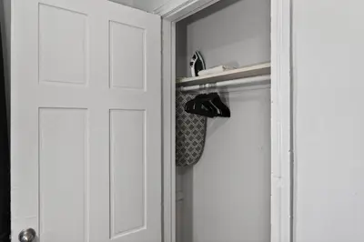 a closet with a white door and a pair of shoes at Sunny 1BR in Center City with King Sized Memory Foam Sofa Bed in Philadelphia
