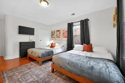 a bedroom with two beds and a flat screen tv at Large Studio in Center City that Sleeps 4 with Fast Wifi in Philadelphia