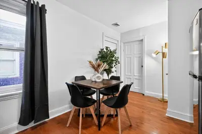 a dining room with a table and black chairs at Large Studio in Center City that Sleeps 4 with Fast Wifi in Philadelphia