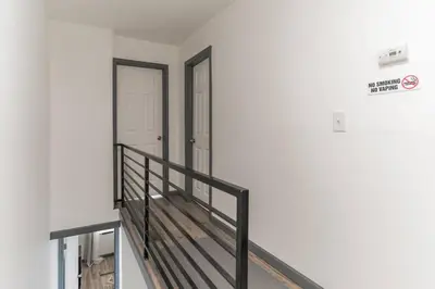 an empty room with a staircase and a door at 5BR - Sleeps 14 - Street Parking - 10 min to DT in Philadelphia